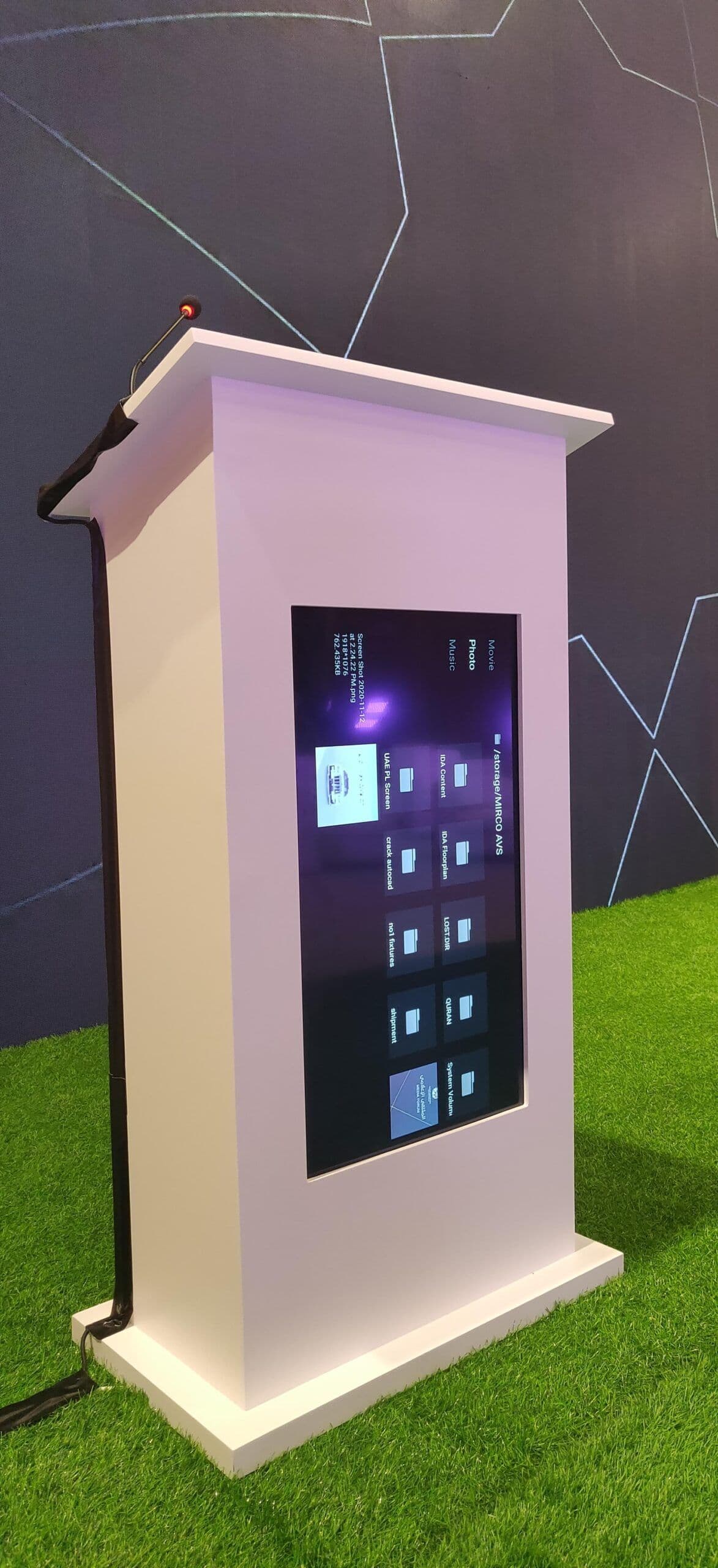 Trade show booth with promotional video playing on vertical screen